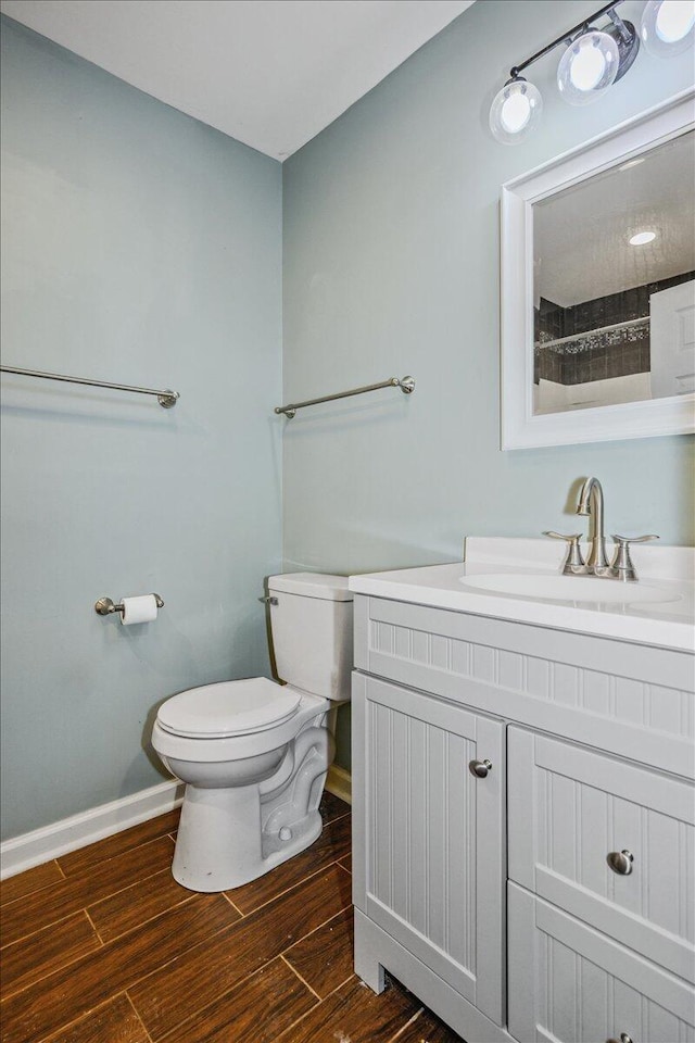 bathroom with vanity, hardwood / wood-style floors, and toilet