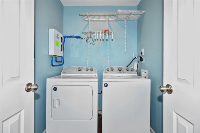 clothes washing area with washer and dryer