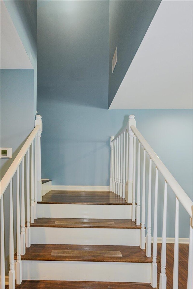 staircase with wood-type flooring