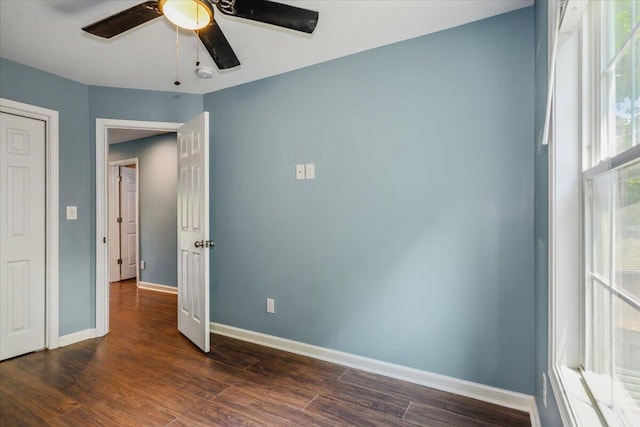 unfurnished bedroom featuring dark hardwood / wood-style floors and ceiling fan