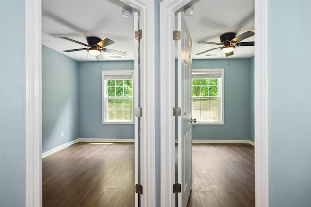 unfurnished room with ceiling fan and dark hardwood / wood-style flooring