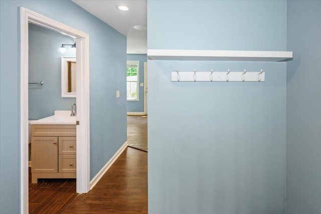 corridor featuring dark hardwood / wood-style floors and sink