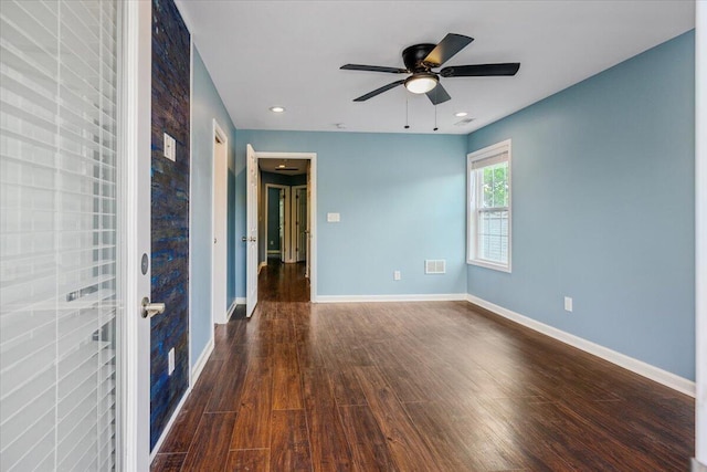 unfurnished room featuring dark hardwood / wood-style flooring and ceiling fan