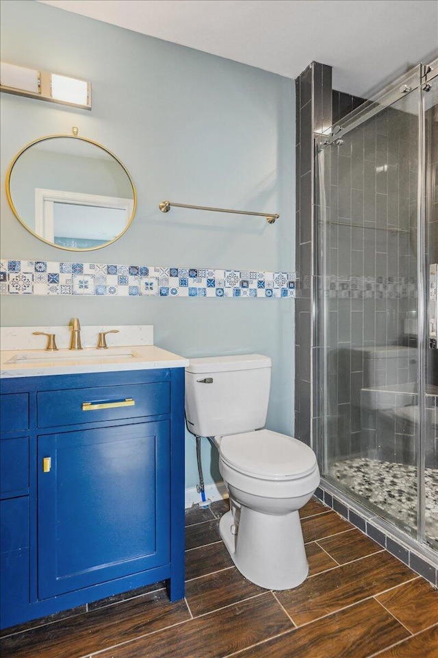 bathroom with vanity, toilet, and an enclosed shower