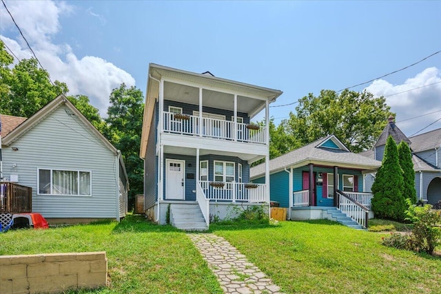 view of front of home with a porch, a balcony, and a front yard