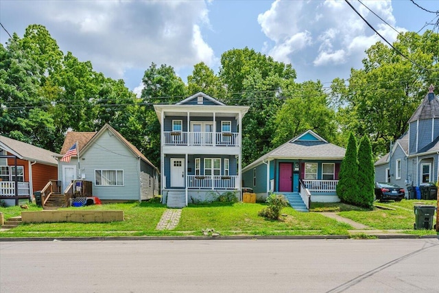 view of front of property with a balcony and a front lawn