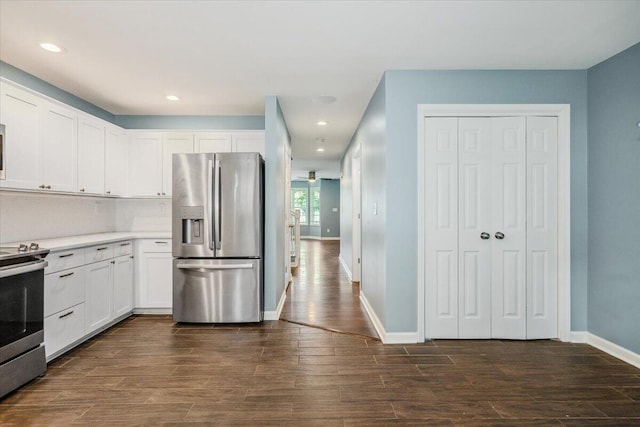 kitchen featuring tasteful backsplash, appliances with stainless steel finishes, dark hardwood / wood-style flooring, and white cabinets