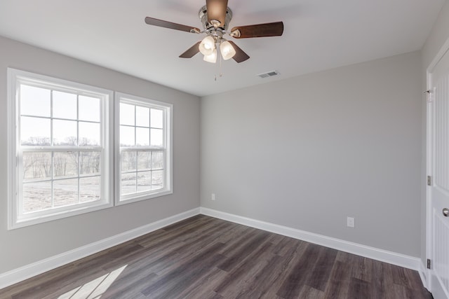 empty room featuring dark wood-type flooring and ceiling fan