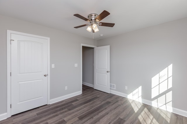 unfurnished bedroom with dark wood-type flooring and ceiling fan