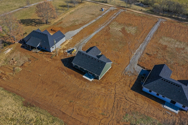 birds eye view of property with a rural view