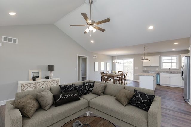 living room featuring hardwood / wood-style flooring, ceiling fan, sink, and high vaulted ceiling