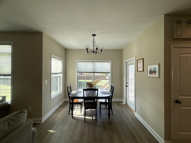 dining room featuring dark hardwood / wood-style flooring and a chandelier