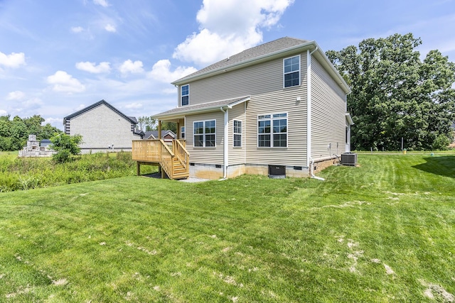 back of house featuring a wooden deck, central AC unit, and a lawn