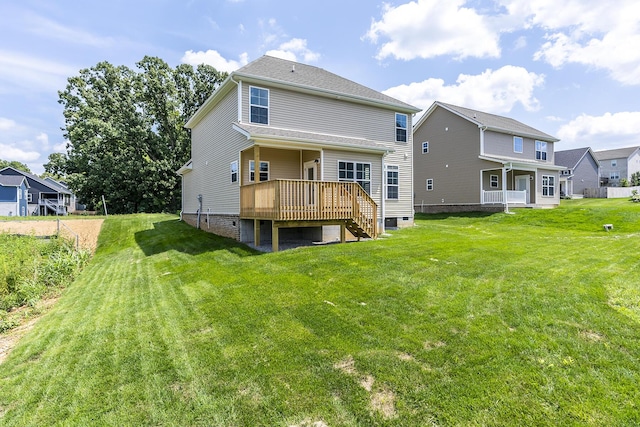 back of property featuring a wooden deck and a lawn