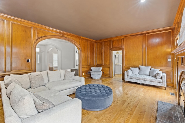 living room featuring ornamental molding and light hardwood / wood-style floors