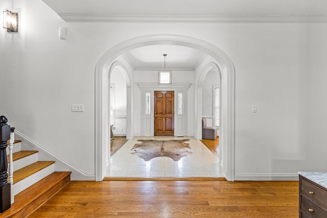 entrance foyer with wood-type flooring and ornamental molding