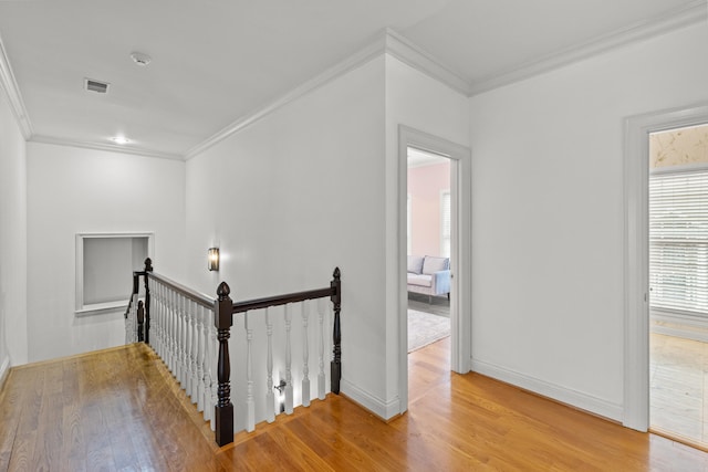 hall featuring crown molding and light hardwood / wood-style flooring