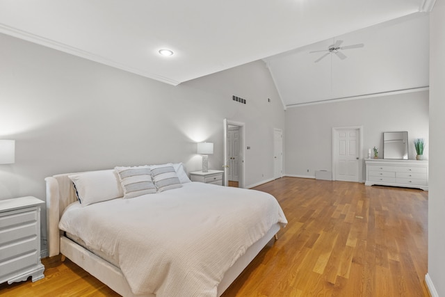 bedroom featuring ceiling fan, high vaulted ceiling, and light wood-type flooring