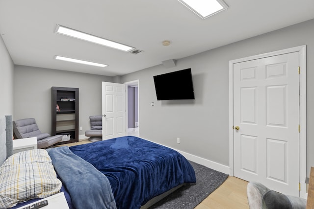 bedroom with hardwood / wood-style flooring