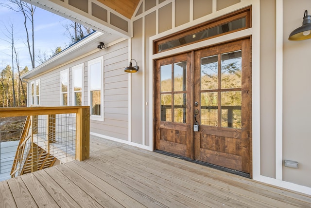 view of exterior entry with french doors and a deck