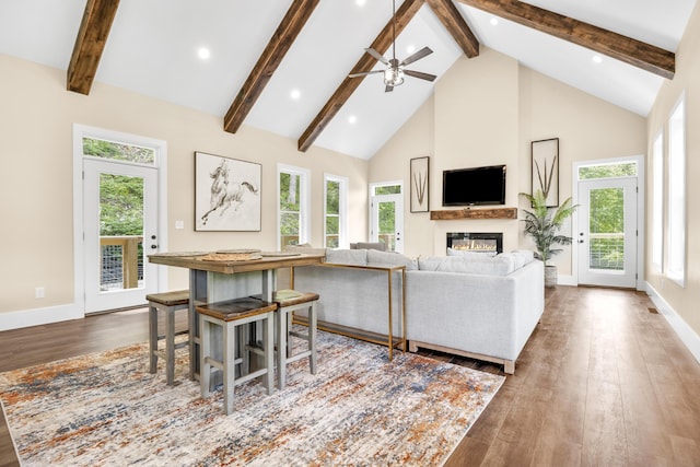 780 Lake Rd, London, KY 40741 - living area featuring beam ceiling, wood finished floors, a glass covered fireplace, high vaulted ceiling, and healthy amount of natural light