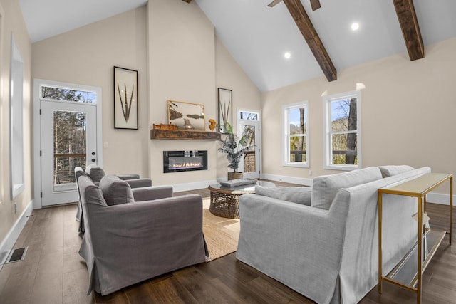 living room with dark wood-type flooring, plenty of natural light, high vaulted ceiling, and beamed ceiling