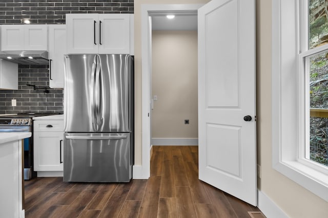 kitchen featuring tasteful backsplash, dark wood-type flooring, stainless steel appliances, and white cabinets