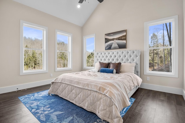 bedroom featuring multiple windows, ceiling fan, lofted ceiling, and dark hardwood / wood-style flooring