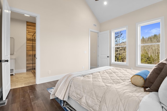 bedroom featuring dark hardwood / wood-style flooring, high vaulted ceiling, and ensuite bathroom