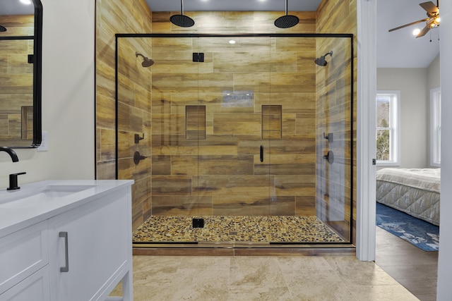 bathroom featuring vanity, ceiling fan, and a shower with shower door