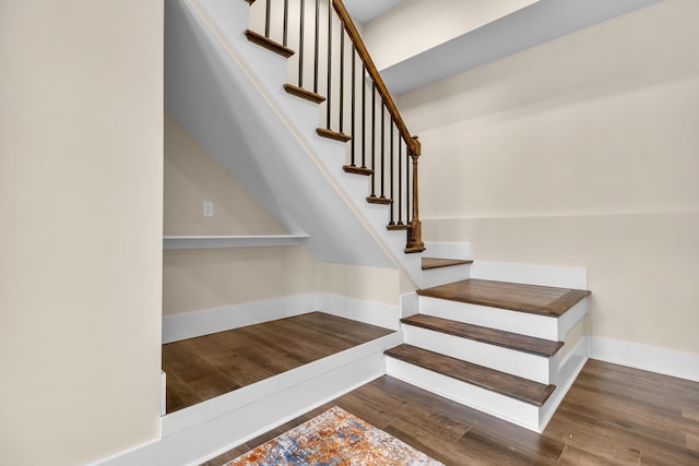 stairway with hardwood / wood-style floors