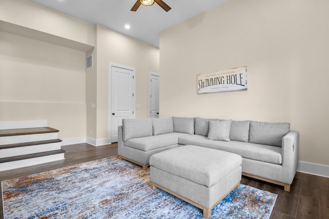 living room with dark hardwood / wood-style floors and ceiling fan