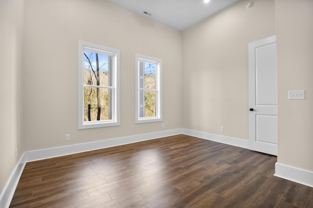 spare room with dark wood-type flooring