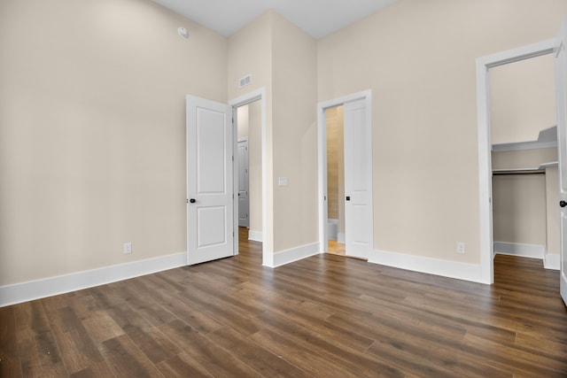 unfurnished bedroom with dark wood-type flooring