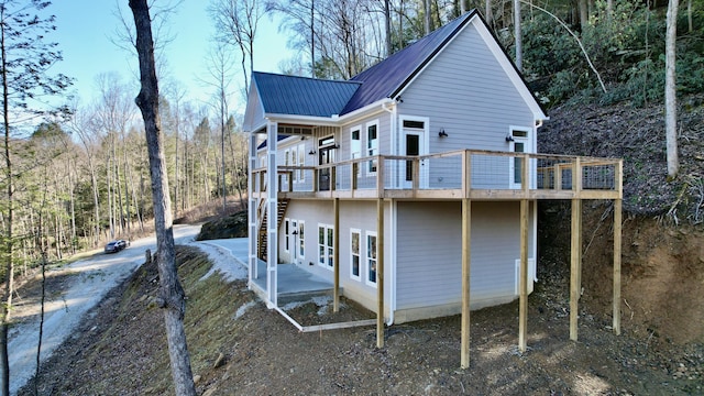 rear view of house featuring a deck