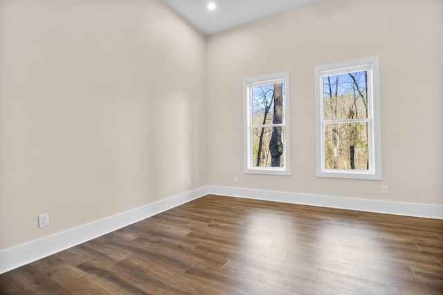 empty room with dark hardwood / wood-style flooring