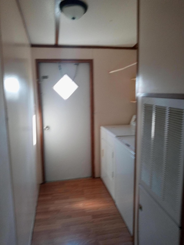 laundry area featuring laundry area, independent washer and dryer, and light wood-type flooring