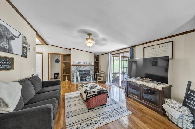 579 Fraley Rd, Salt Lick, KY 40371 - living room with lofted ceiling, a stone fireplace, wood finished floors, a ceiling fan, and crown molding