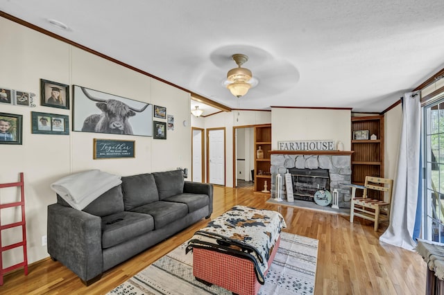 579 Fraley Rd, Salt Lick, KY 40371 - living room with wood finished floors, a stone fireplace, ceiling fan, and ornamental molding