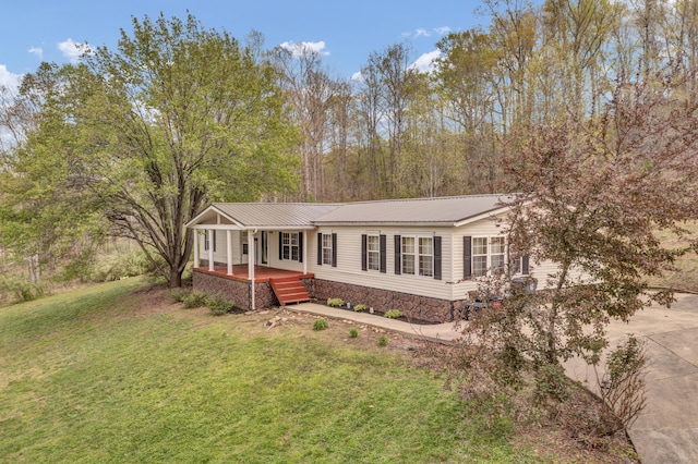 579 Fraley Rd, Salt Lick, KY 40371 - view of front of home featuring metal roof, driveway, a front yard, and covered porch