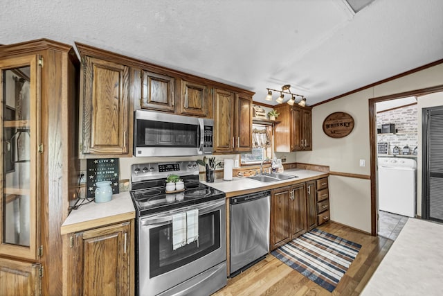 579 Fraley Rd, Salt Lick, KY 40371 - kitchen with stainless steel appliances, light countertops, a sink, washer / dryer, and light wood-style floors