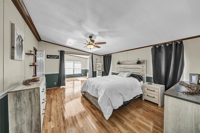 579 Fraley Rd, Salt Lick, KY 40371 - bedroom featuring vaulted ceiling, a ceiling fan, wood finished floors, a textured ceiling, and ornamental molding