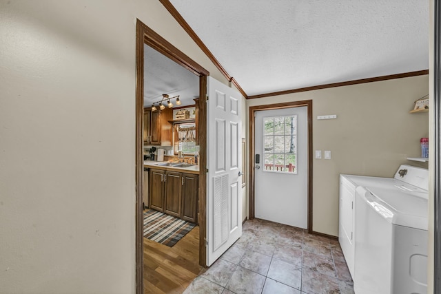 579 Fraley Rd, Salt Lick, KY 40371 - laundry area with laundry area, a sink, crown molding, separate washer and dryer, and a textured ceiling