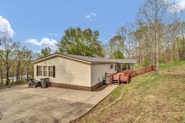 579 Fraley Rd, Salt Lick, KY 40371 - back of property with cooling unit, a lawn, metal roof, and a deck
