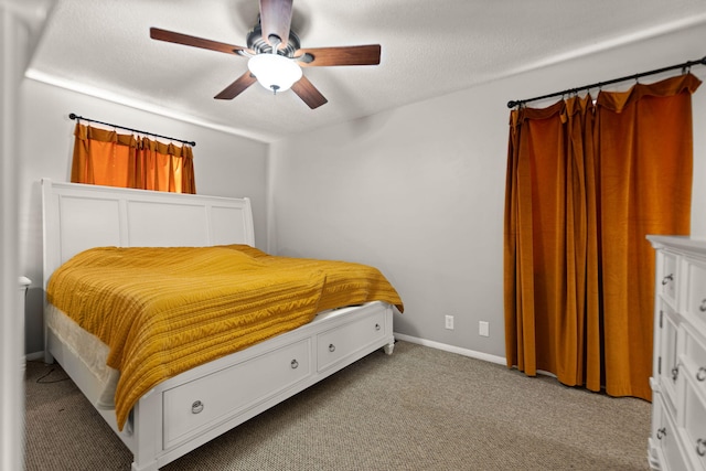 carpeted bedroom featuring ceiling fan and a textured ceiling