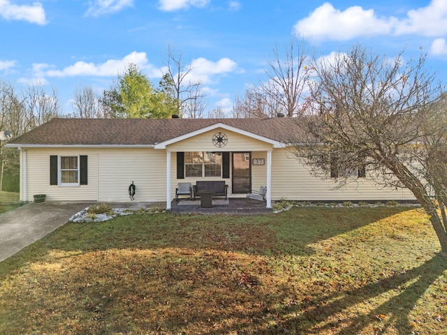 single story home featuring a front lawn and a patio