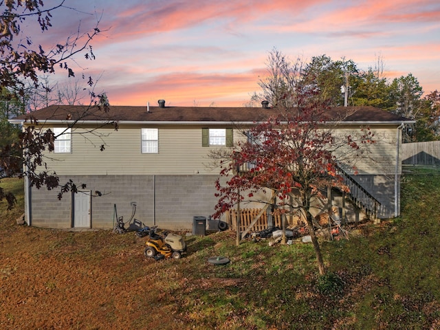 back house at dusk with a yard