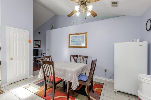 dining room featuring visible vents, lofted ceiling, light tile patterned flooring, and a ceiling fan