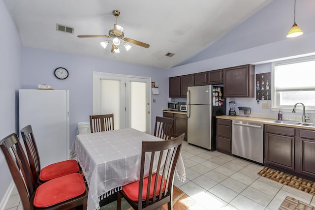 kitchen featuring visible vents, dark brown cabinets, stainless steel appliances, a ceiling fan, and a sink