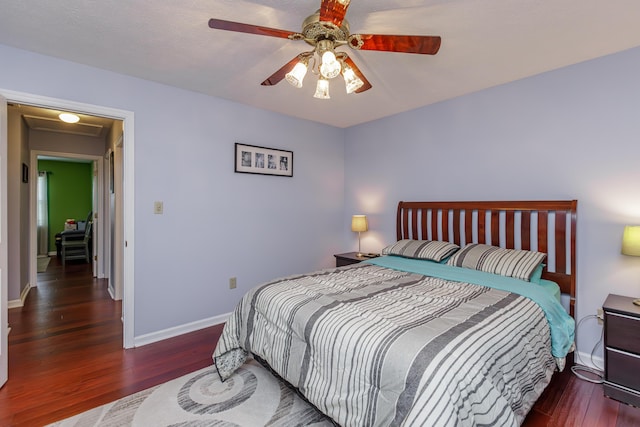 bedroom with wood finished floors, baseboards, and ceiling fan